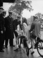 College Girls on Bicycles Stopping to Chat with Cadets
