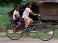 Girls Riding Bicycle in Bavel Village, Battambang, Cambodia