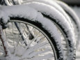 Snow Covered Bicycles Parked in Town